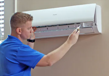 Ductless mini-split system AC evaporator unit located inside the home