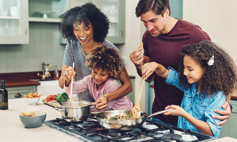 Happy family using Santoro Propane to cook dinner