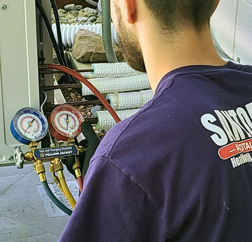 Santoro technician checking coolent levels in AC compressor