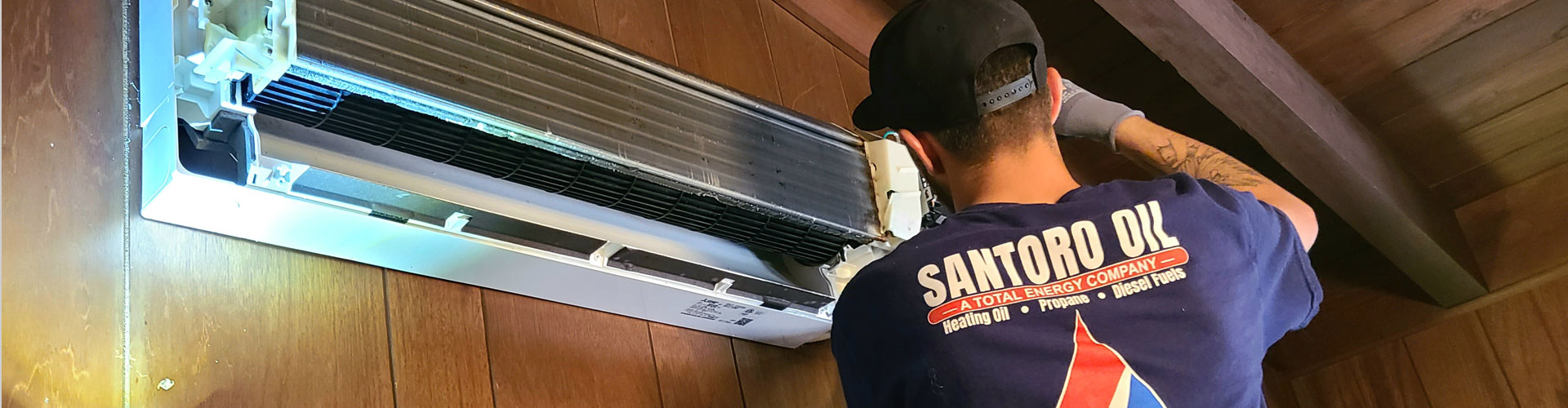 Santoro technician performing maintenance on a ductless AC unit