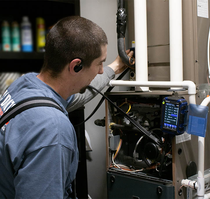 Santoro technician performing maintenance on a gas fired furnace